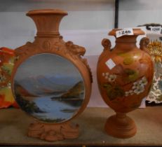 A Watcombe Torquay moonflask with moulded lion mask border and central hand painted panel, depicting