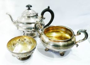 An antique English silver teapot with embossed scroll decoration - sold with a large silver sugar