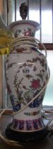 A modern Chinese ceramic table lamp of vase form with floral and butterfly decoration, set on pierce