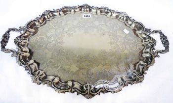A large late Victorian silver plated tea tray with ornate cast rim and engraved decoration