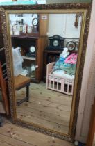 A reproduction ornate gilt framed bevelled oblong wall mirror