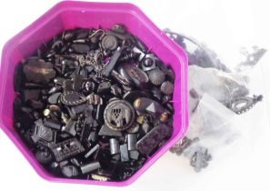 A tub containing a quantity of assorted jet brooches, beads and other items - various condition