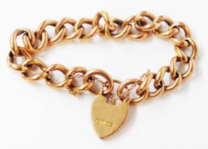 A marked 9ct. rose metal kerb-link bracelet with heart shaped padlock and safety chain