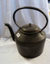 An old large cast iron black painted kettle