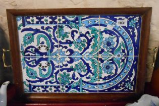 An old tea tray with brass handles and inset six tile panel in the Iznik manner