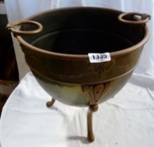 A tripedal brass coal bucket with embossed decoration and handles either side