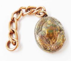 A damaged silver oval locket on a small length of 375 (9ct.) rose gold chain (links stamped)