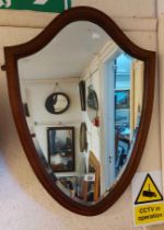 An Edwardian mahogany and strung framed shield shaped wall mirror with bevelled plated