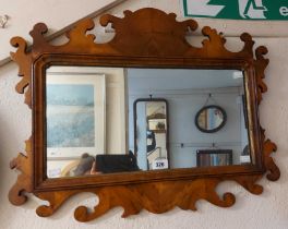 A vintage Georgian style walnut veneered fret-cut wall mirror with gilt border to the oblong plate -