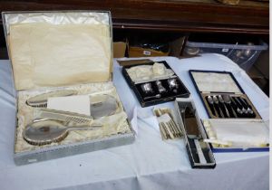 A boxed vintage silver plated mounted hand mirror and brush set with engraved 'L' initials - sold