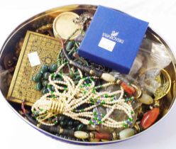 A tin containing a quantity of assorted costume and other jewellery, part items, etc.