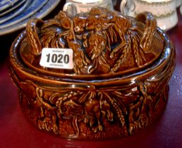 A Portmeirion pottery game pie dish with moulded decoration and a brown treacle glaze finish