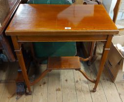 A 71cm Edwardian mahogany, crossbanded and strung fold-over card table with raised shaped undertier,