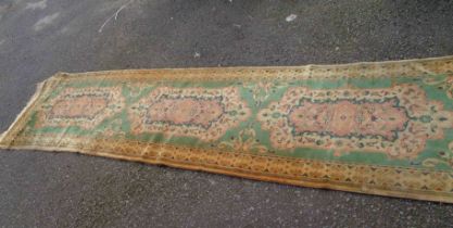 A vintage Chinese handmade washed wool runner with three medallion within a wide border on jade