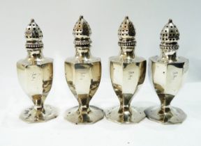 A set of four marked 'sterling' pepperettes of faceted baluster form with beaded push-fit tops