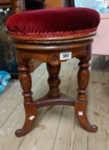 An Edwardian mahogany adjustable piano stool with burgundy velour upholstered seat and screw action,