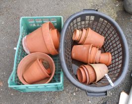 Two crates containing a quantity of terracotta pots