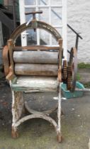 An old cast iron mangle with white painted finish