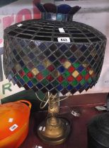 A large brass coloured metal lamp with handmade Tiffany style coloured glass shade