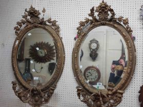 A pair of 98cm high 19th Century ornate gilt framed pier mirrors with gesso wired pediments and