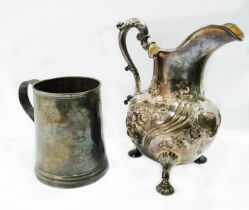 An early Victorian silver large cream jug with embossed decoration and scroll handle, set on