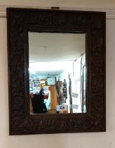 A small carved oak framed oblong wall mirror - sold with a small gilt framed oval similar