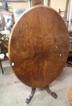 A 1.34m Victorian figured walnut tilt-top loo table with quarter veneered top, set on a bulbous