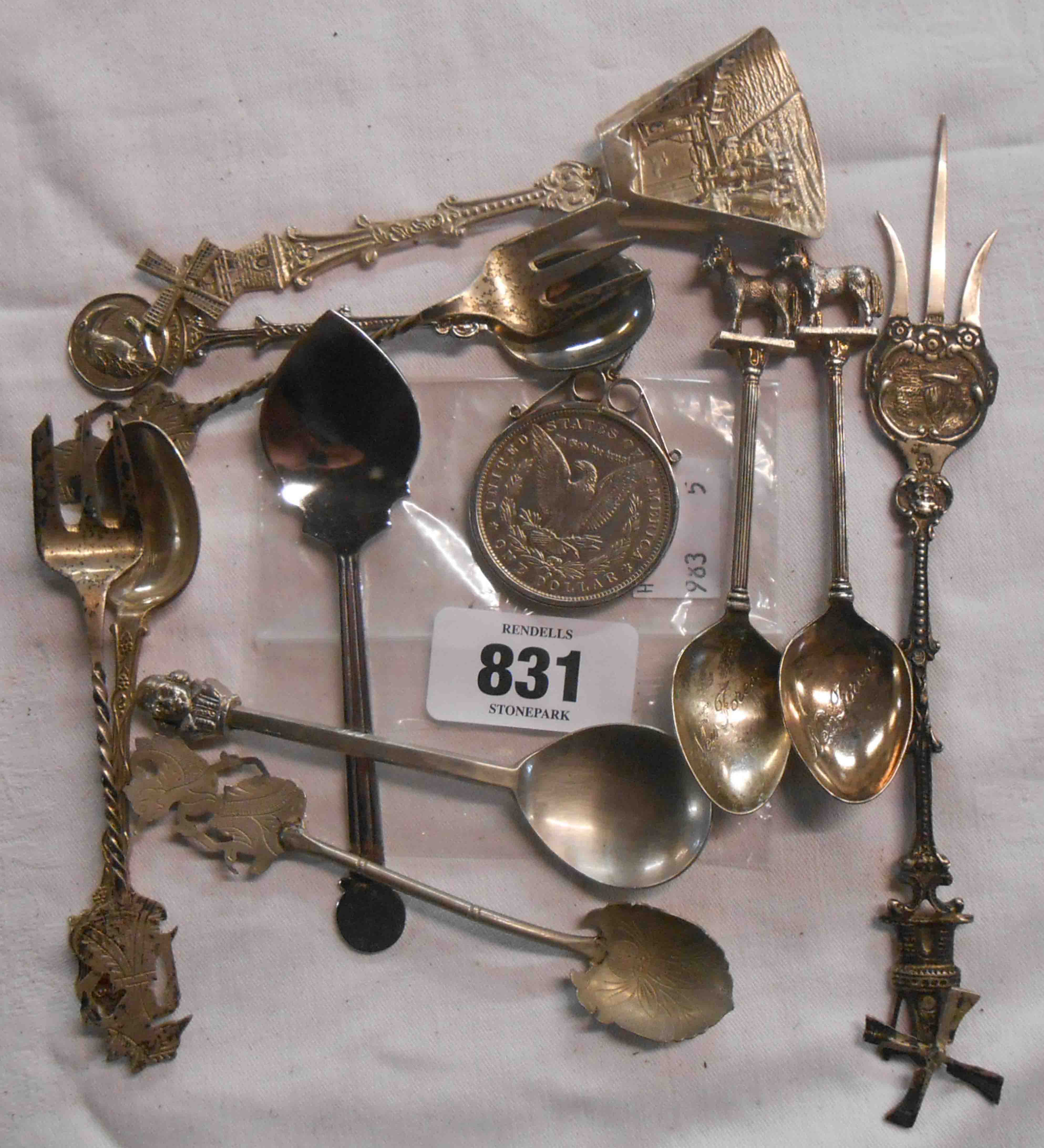 A silver dollar and a quantity of souvenir spoons