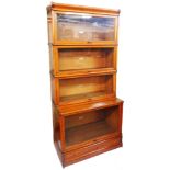 An 86cm early 20th Century Globe Wernicke light oak four section modular bookcase with cornice and