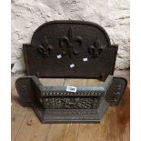 An old cast metal fire grate front - sold with a similar cast iron fire back with fleur de lys