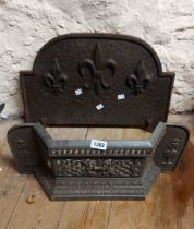 An old cast metal fire grate front - sold with a similar cast iron fire back with fleur de lys