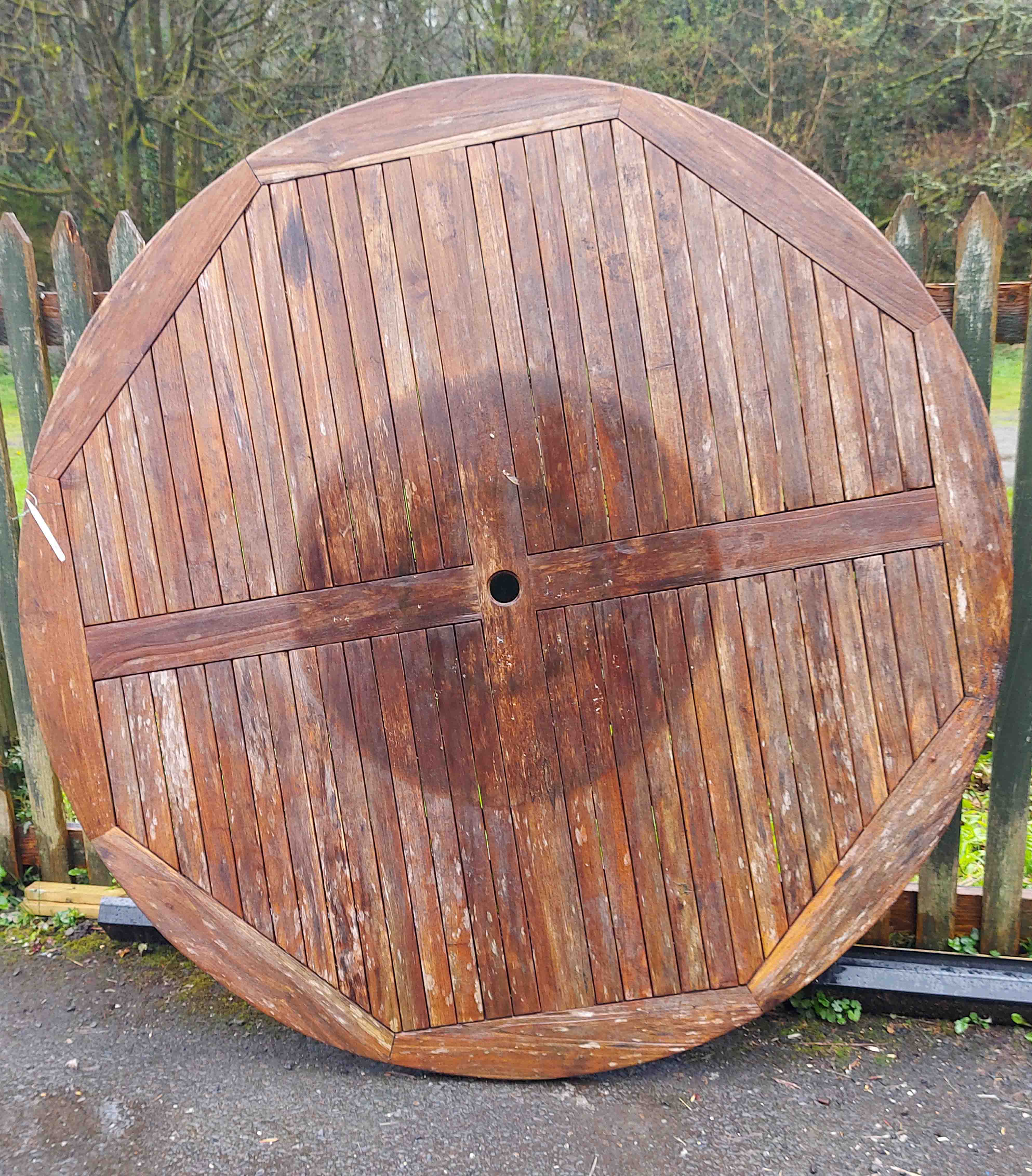 A circular garden table, set on four bolt-on legs