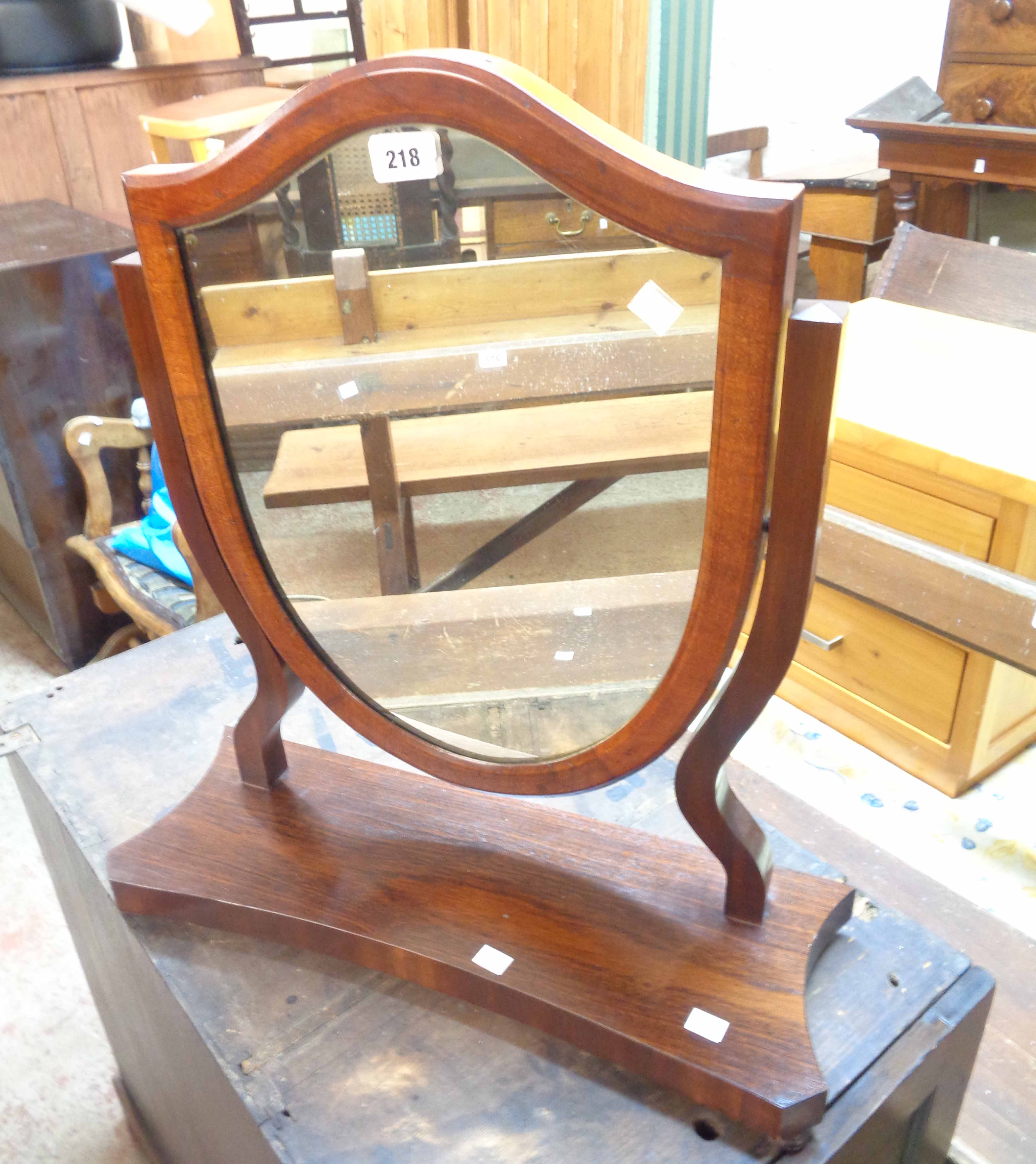 An Edwardian mahogany platform dressing table mirror with shield shaped plate