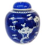 An antique Chinese porcelain ginger jar and lid with blue painted prunus decoration