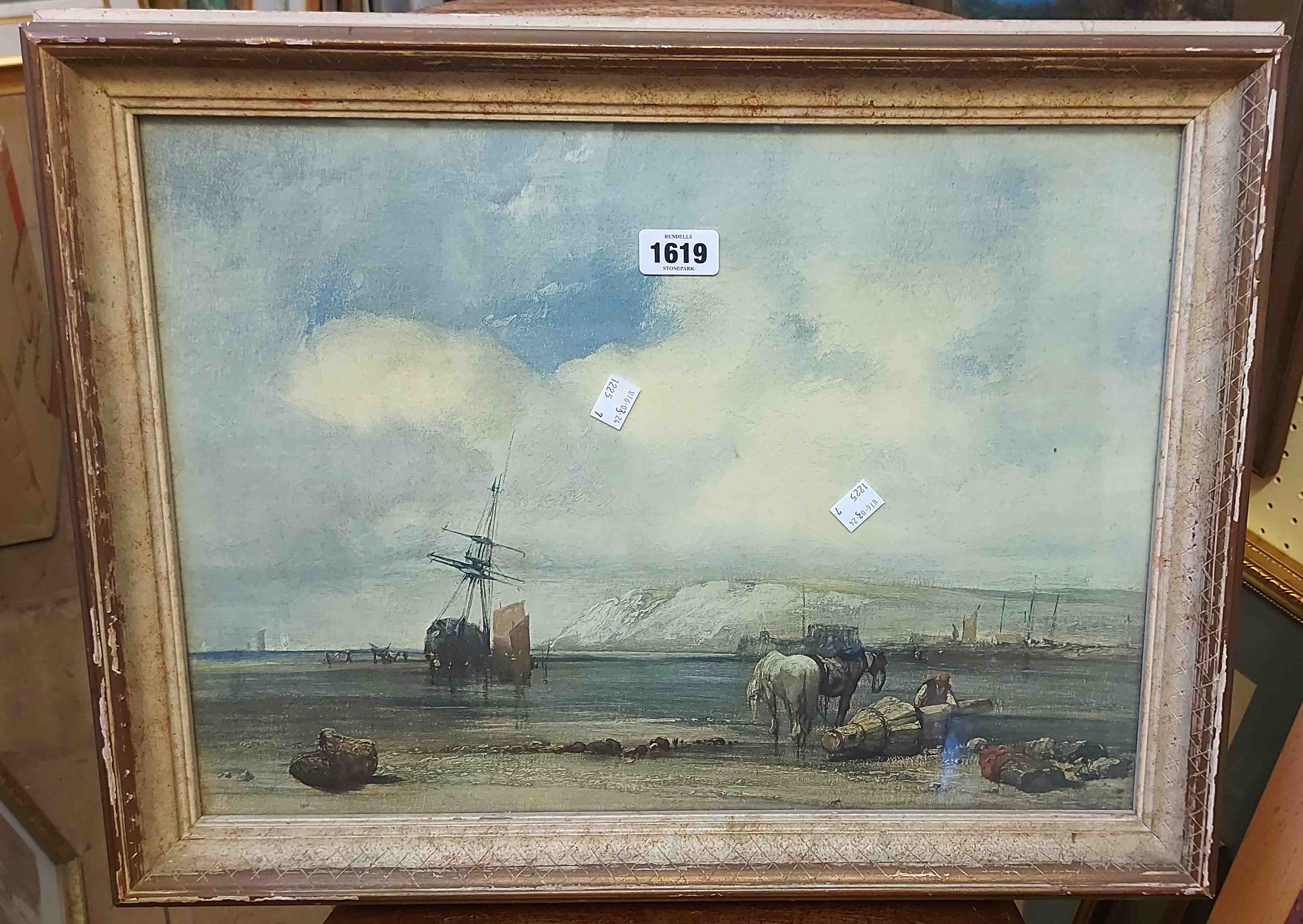 A framed vintage coloured print, depicting a figure and horses on a shoreline with moored sailing