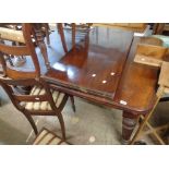 A late Victorian mahogany extending dining table with two leaves, set on heavy turned and fluted