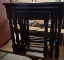 A vintage oak nest of three tea tables, set on turned supports