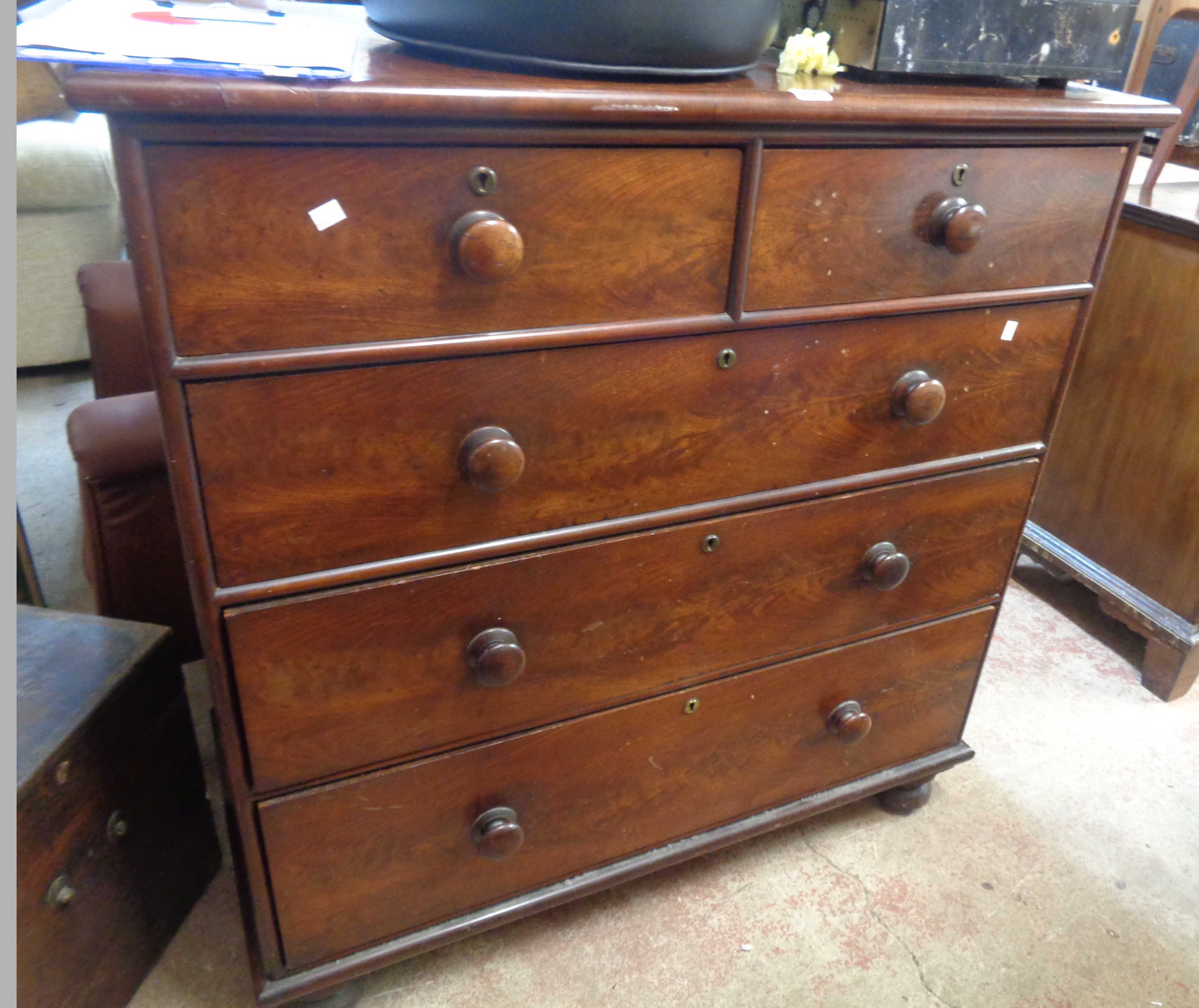 A 1.12m Victorian mahogany chest of two short and three long graduated drawers, set on heavy