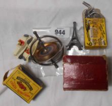 An Eiffel Tower spinning top toy - sold with two Lesney Yesteryear model vintage cars and a boxed