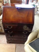 A 60cm reproduction mahogany and crossbanded bureau with part fitted interior and four long