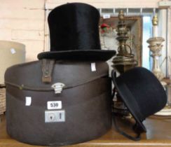 A hat box containing an A.J. White Ltd. bowler hat and a Battersby & Co. top hat