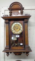 A late 19th Century simulated inlaid walnut cased wall clock with decorative dial and spring
