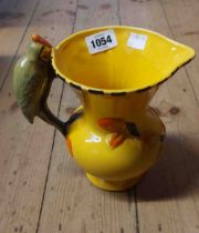 An Art Deco Wade Heath jug with moulded parrot handle and vibrant hand painted finish