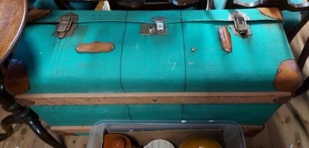 A large vintage green canvas coated and leather mounted travelling trunk with tray fitted interior