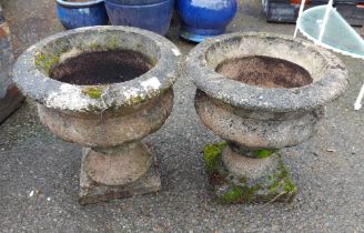 Two concrete urn form planters