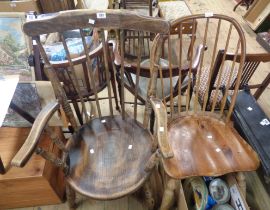 An old Windsor style comb back stained mixed wood elbow chair with solid seat, set on ring turned