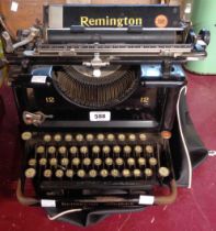 A large antique Remington typewriter with vinyl cover