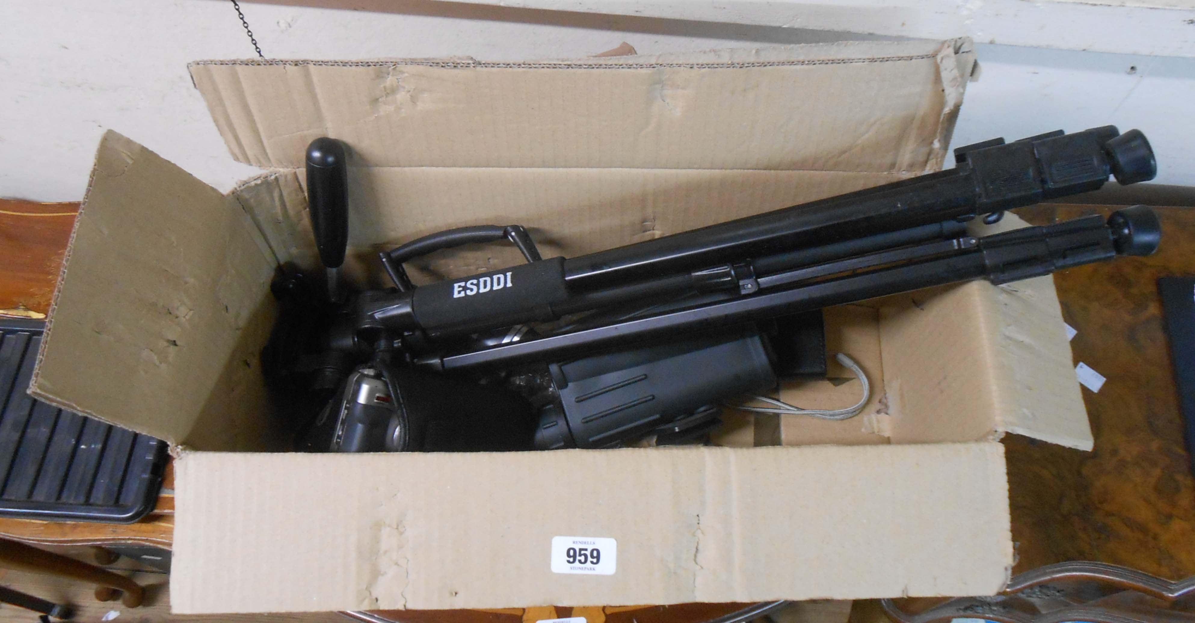 A box containing a Ricoh digital camera, a tripod, binoculars, etc.