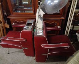 A pair of vintage salon hairdresser's chairs, upholstered in red leatherette - sold as a collector's
