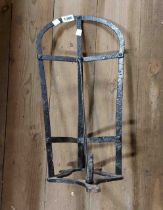 A wrought iron saddle rack